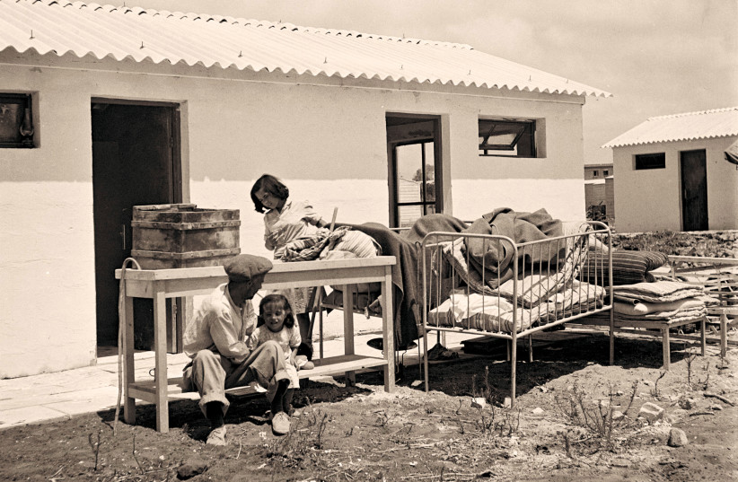  ‘ASBESTOS VALLEY’ origins: A family of new immigrants move into one of the huts at a Ma’abara, near Tel Aviv.  (photo credit: Wikimedia Commons)
