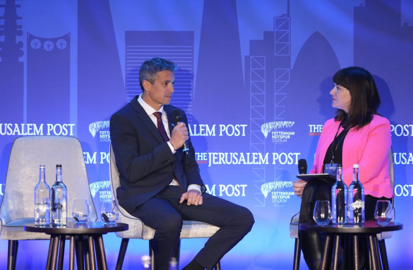   Communications Minister Yoaz Hendel speaks to reporter Lahav Harkov at the Jerusalem Post London Conference on March 31, 2022 (credit: MARC ISRAEL SELLEM/THE JERUSALEM POST)