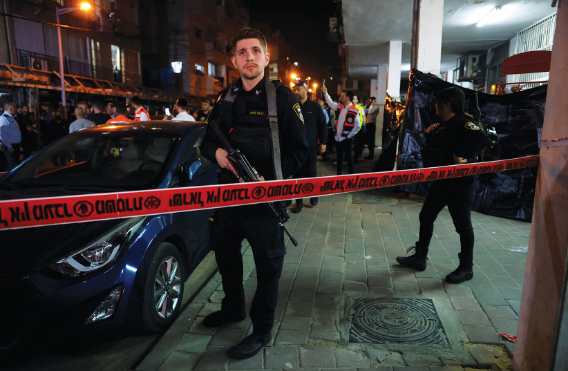  POLICE OFFICERS secure the scene of Tuesday night’s deadly terror attack in Bnei Brak. (photo credit: NIR ELIAS/REUTERS)