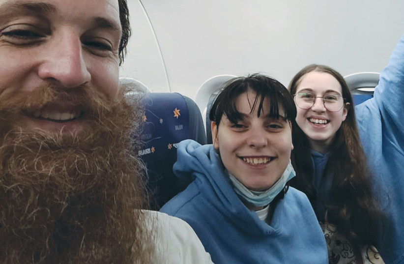  RABBI YOSSI GLICK accompanies two girls from the Chabad Ukraine Orphanage on a plane from Romania to Israel following their 22-hour train journey to Romania. (photo credit: RABBI YOSSI GLICK)