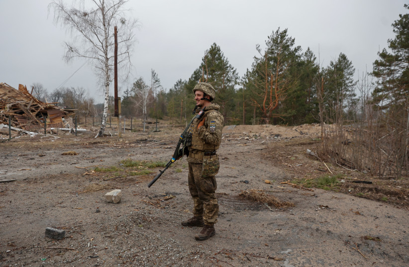  A Ukrainian service member patrols an area in a village near a frontline, as Russia's attack on Ukraine continues, in Kyiv Region, Ukraine March 31, 2022. (photo credit: Serhii Nuzhnenko/Reuters)