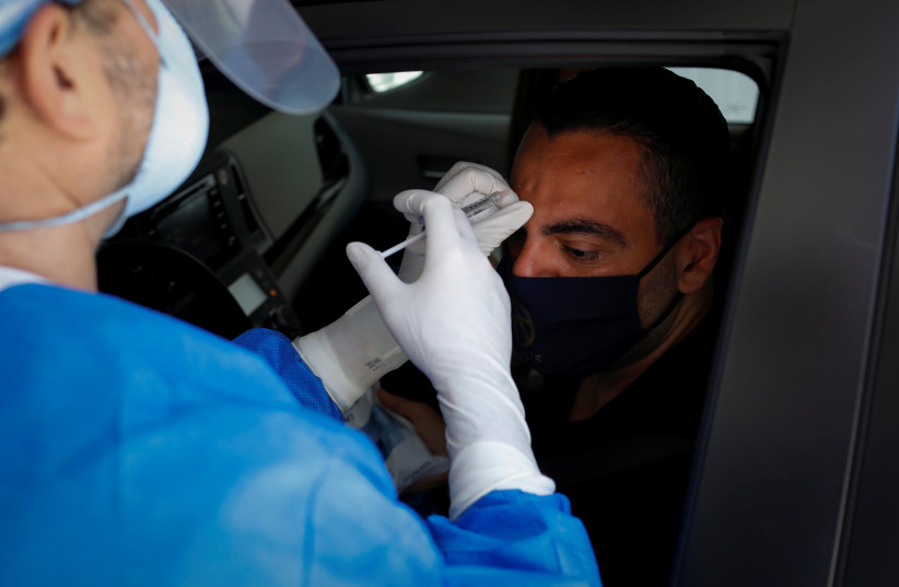  Michael Salzhauer, a plastic surgeon known as Dr. Miami, applies Botox to a patient while conducting drive-through Botox injections in the garage of his clinic, as Miami-Dade County eases some of the lockdown measures put in place during the coronavirus disease (COVID-19) outbreak, in Miami, Florid (credit: REUTERS/MARCO BELLO)