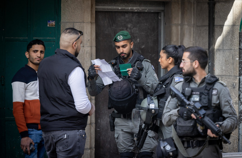  Israeli border police officers check Palestinian men and their ID's in Jerusalem's Old City on April 1, 2022. (photo credit: YONATAN SINDEL/FLASH90)