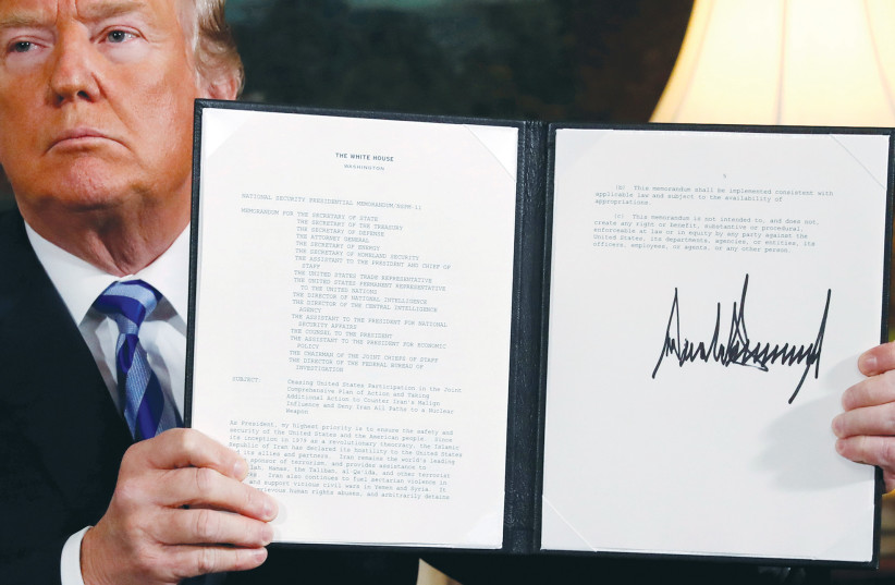  THEN-US PRESIDENT Donald Trump holds up a proclamation in 2018, declaring his intention to withdraw from the JCPOA nuclear agreement. The nuclear deal now taking shape is probably the lesser of the evils given Trump’s reckless pullout from the original pact. (photo credit: JONATHAN ERNST/REUTERS)