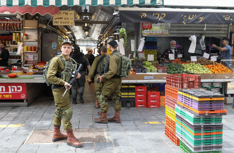 IDF soldiers patrol Jerusalem's Mahane Yehuda market on April 3, 2022 (credit: MARC ISRAEL SELLEM/THE JERUSALEM POST)