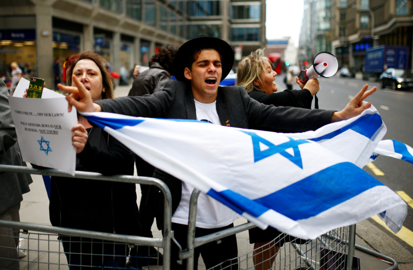  Demonstrators take part in protests outside a meeting of the National Executive of Britain's Labour Party which will discuss the party's definition of antisemitism, in London (photo credit: REUTERS/HENRY NICHOLLS)
