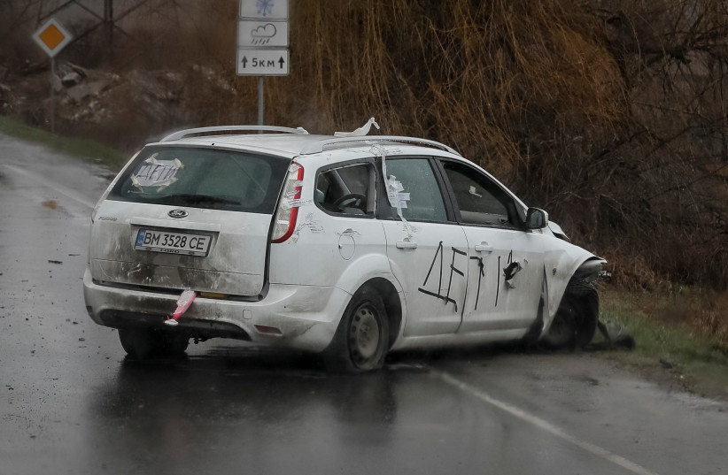  A shot car with inscriptions "Children" is seen on the street, amid Russian invasion on Ukraine, in Bucha, Kyiv region, Ukraine April 3, 2022. (photo credit: GLEB GARANICH/REUTERS)