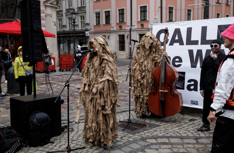  A member of Kalush Orchestra, Ukraine's representative for the 2022 Eurovision contest, performs at Rynok square, as Russia's attack on Ukraine continues, in Lviv, Ukraine, April 2, 2022 (photo credit: REUTERS/ALKIS KONSTANTINIDIS)