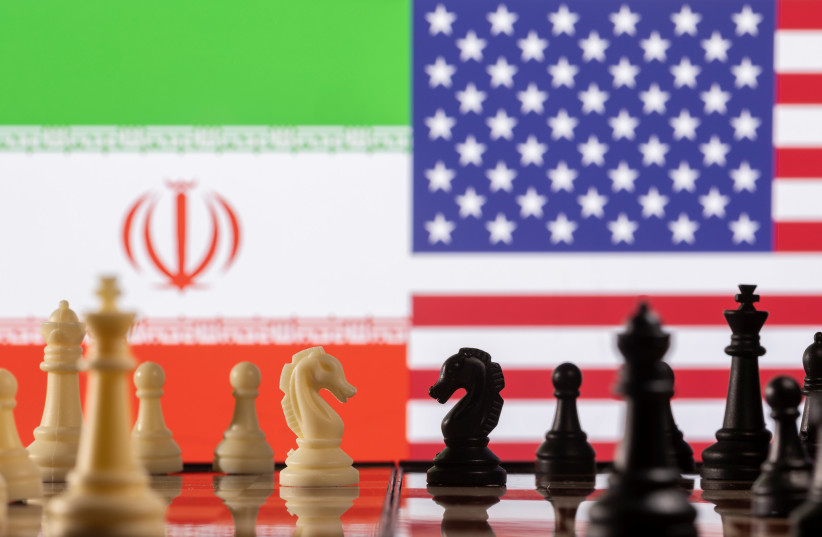  Chess pieces are seen in front of displayed Iran's and U.S. flags in this illustration taken January 26, 2022. (photo credit: REUTERS/DADO RUVIC/ILLUSTRATION)