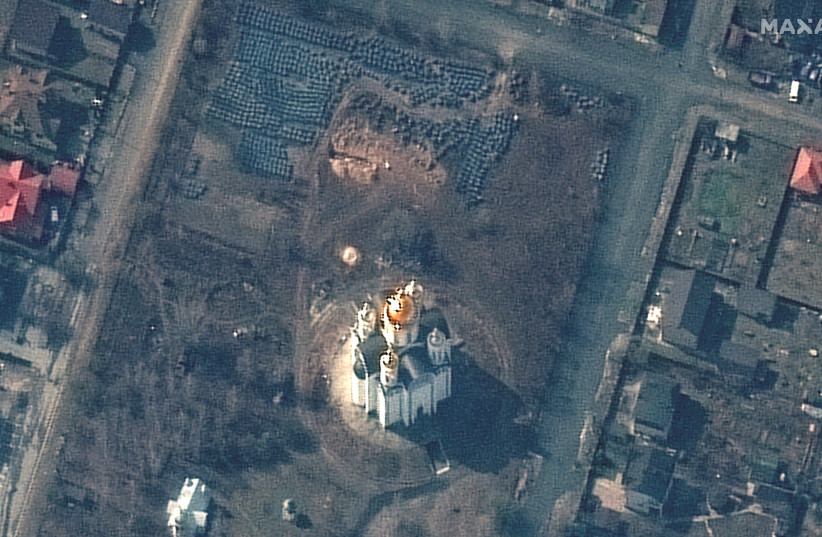  A satellite image shows the grave site with an approximately 45-foot (approximately 13,7 meters) long trench in the southwestern section of the area near the Church of St. Andrew and Pyervozvannoho All Saints, in Bucha, Ukraine, March 31, 2022.  (credit: MAXAR TECHNOLOGIES/HANDOUT VIA REUTERS)