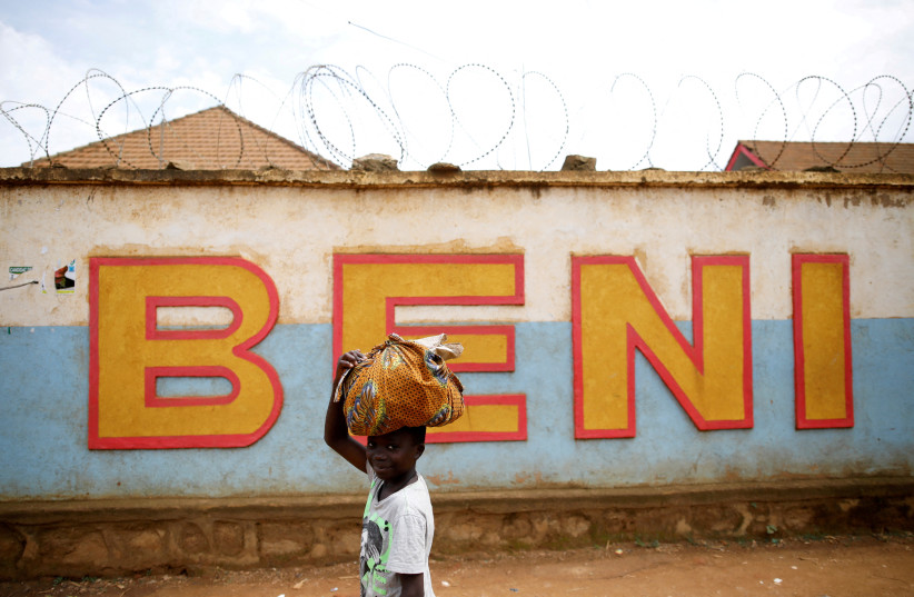  A Congolese boy walks past a wall in Beni, in the Democratic Republic of Congo, April 1, 2019. Picture taken April 1, 2019. (credit: REUTERS/BAZ RATNER)