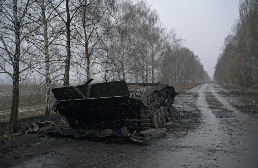 A destroyed armoured vehicle, with the letter "V" painted on it, is seen on a road, as Russia's invasion of Ukraine continues, near the village of Motyzhyn in the Kyiv region, Ukraine March 2, 2022. (photo credit: REUTERS/MAKSIM LEVIN)