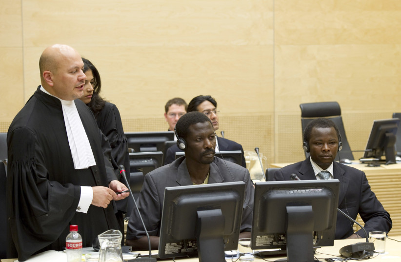 Karim Khan (L), the lawyer for Abdallah Banda Abakaer Nourain (C) and Saleh Mohammed Jerbo Jamus (R), both suspected of having committed war crimes in Darfur, speaks at the International Criminal Court in The Hague June 17, 2010. (credit: REUTERS/Toussaint Kluiters/United Photos)