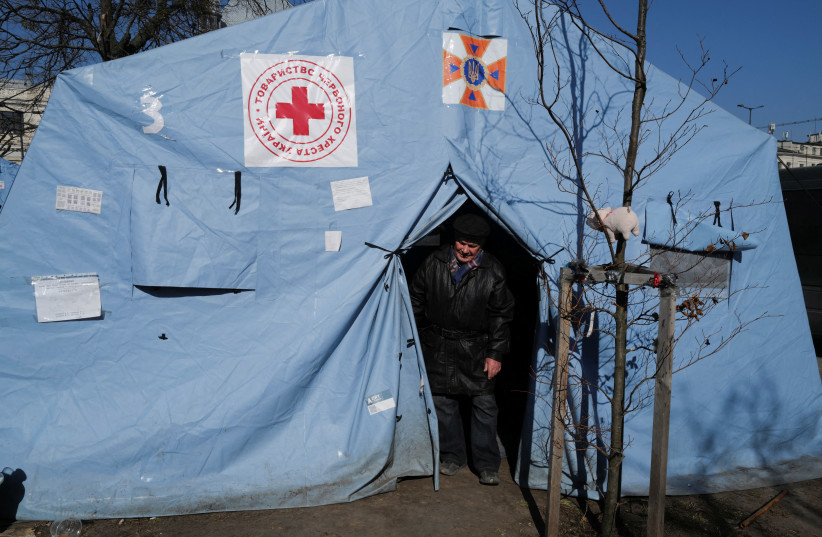  A man fleeing Russia's invasion of Ukraine walks out the Red Cross tent, outside the train station in Lviv, Ukraine March 21, 2022.  (photo credit: REUTERS/ZOHRA BENSEMRA)