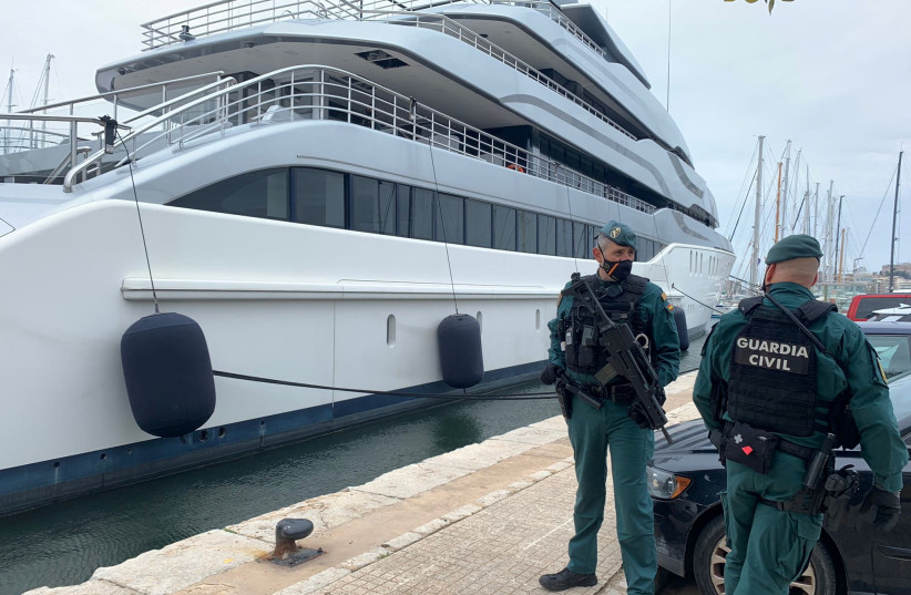  Spanish Civil Guards stand by the Tango superyacht, suspected to belong to a Russian oligarch, as it is docked at the Mallorca Royal Nautical Club, in Palma de Mallorca, in the Spanish island of Mallorca, Spain, April 4, 2022. (photo credit: Juan Poyates Oliver/Handout via REUTERS)