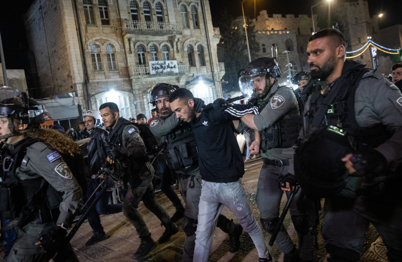  Israeli police officers arrest a man during clashes with protesters at Damascus Gate in Jerusalem's Old City, on the holy Muslim month of Ramadan, April 4, 2022. (photo credit: YONATAN SINDEL/FLASH90)