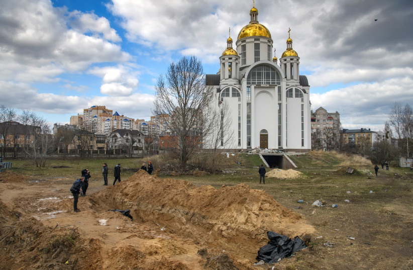  A mass grave with bodies of civilians, who according to local residents were killed by Russian soldiers, is seen, as Russia's attack on Ukraine continues, in Bucha, in Kyiv region, Ukraine April 4, 2022.  (credit: REUTERS/VLADYSLAV MUSIIENKO)