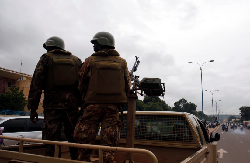  Malian soldiers patrol in Bamako, Mali July 27, 2018. Picture taken July 27, 2018. (photo credit: REUTERS/LUC GNAGO)