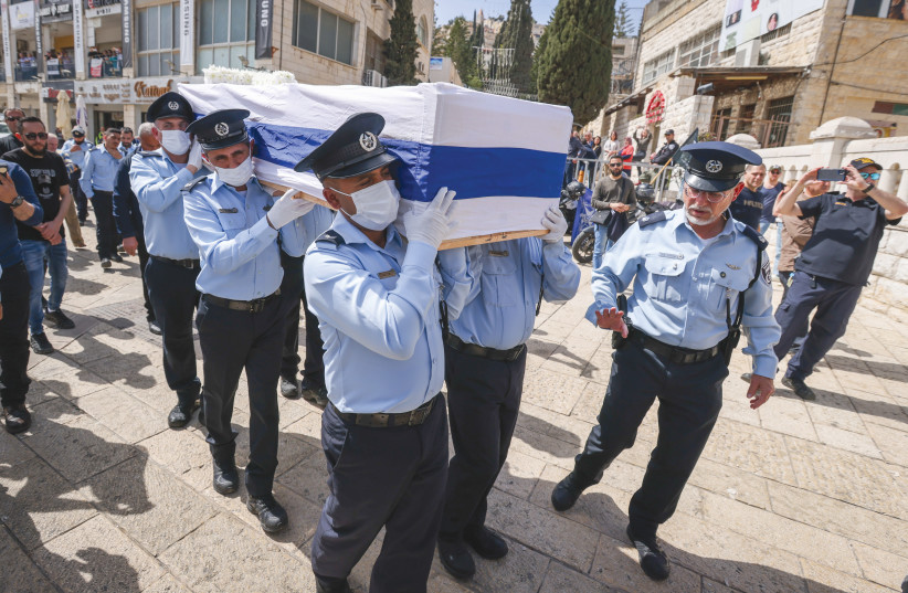  ISRAELI POLICE officers carry the coffin of comrade Amir Khoury during his funeral service in Nazareth last Thursday, after he was killed in a terrorist shooting in Bnei Brak.  (photo credit: David Cohen/Flash90)