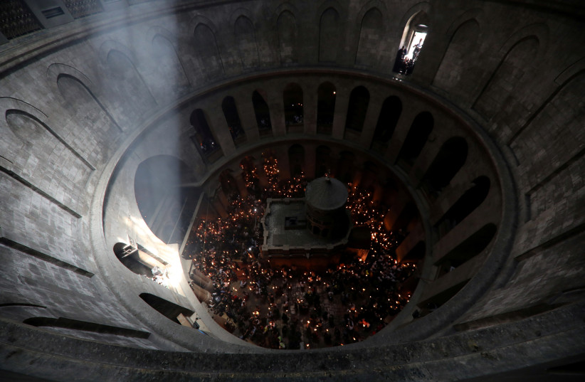  Orthodox Christian worshippers attend the Holy Fire ceremony amid eased coronavirus disease (COVID-19) restrictions at the Church of the Holy Sepulchre in Jerusalem's Old City, May 1, 2021. (photo credit: REUTERS/AMMAR AWAD)