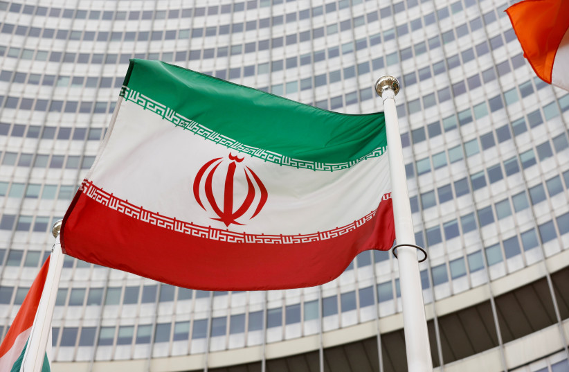  The Iranian flag waves in front of the International Atomic Energy Agency (IAEA) headquarters, amid the coronavirus disease (COVID-19) pandemic, in Vienna, Austria May 23, 2021. (credit: REUTERS/LEONHARD FOEGER)