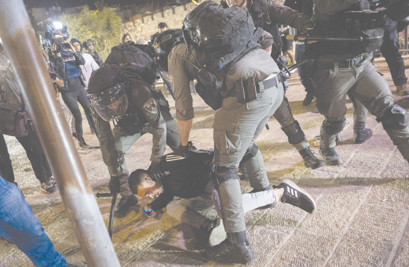  ISRAELI POLICE arrest a man during confrontations with protesters at Damascus Gate of Jerusalem’s Old City on April 4, 2022. (photo credit: YONATAN SINDEL/FLASH90)