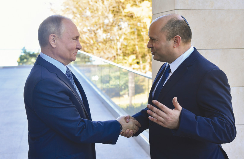  RIME MINISTER Naftali Bennett shakes hands with Russian President Vladimir Putin at a meeting in Sochi, last October. (photo credit: Sputnik/Kremlin/Reuters)