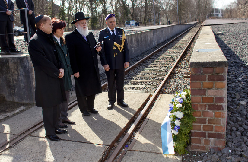  RECITING THE kaddish prayer at a memorial at Grunewald railway station in Berlin, where Jews were deported to concentration camps. In the book, a key character-atheist says kaddish for the father, but feels nothing (Illustrative). (photo credit: THOMAS PETER/REUTERS)
