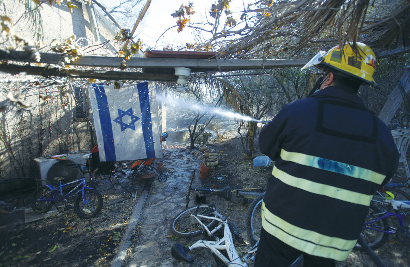  A FIREFIGHTER douses flames in Yemin Orde, near Haifa, during the massive 2010 Carmel fire. Sophisticated firefighting equipment can dramatically reduce the amount of damage.  (photo credit: ABIR SULTAN/FLASH90)