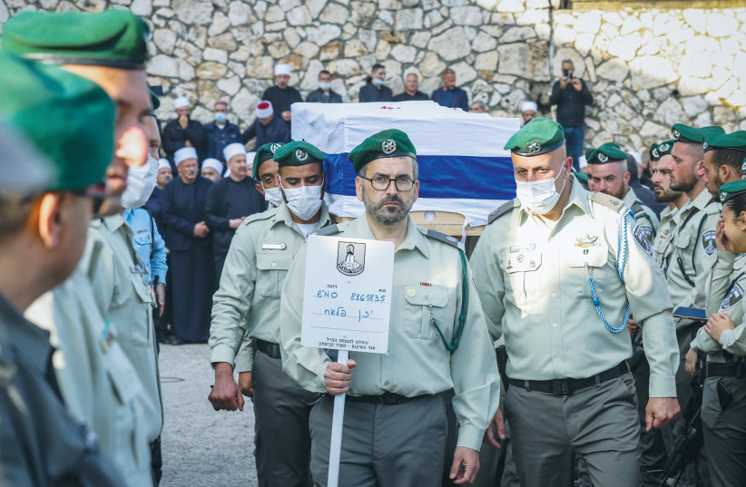  COMRADES CARRY the body of Border Police officer Yazan Falah, at his funeral in Kisra-Sumei, a day after he was murdered in the Hadera terror attack last month.  (photo credit: David Cohen/Flash90)