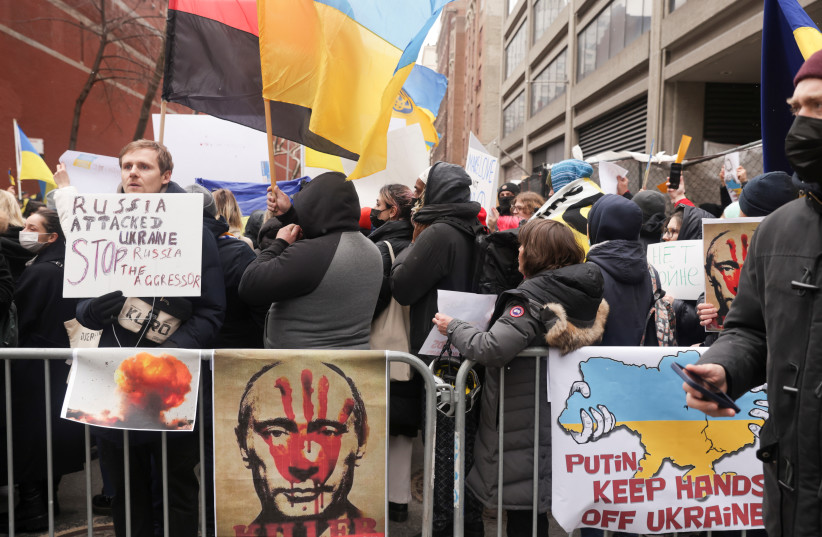  People take part in a protest against Russia's invasion of Ukraine, outside the Russian Mission to the United Nations in New York City, US, February 24, 2022.  (photo credit: JEENAH MOON/REUTERS)