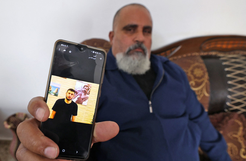  A Palestinian man displays a picture of his nephew Raad Hazem, 28, a Palestinian gunman who had killed two people and wounded several others in Tel Aviv the previous night, on April 8, 2022 in the West Bank city of Jenin.  (credit: JAAFAR ASHTIYEH/AFP via Getty Images)