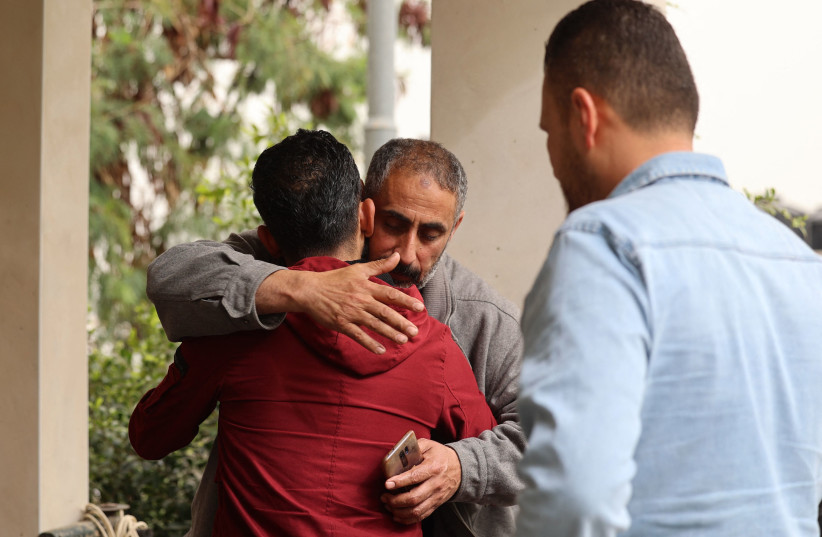 The father of Raad Hazem, 28, a Palestinian gunman who had killed two people and wounded several others in Tel Aviv the previous night, hugs a friend at this home on April 8, 2022 in the West Bank city of Jenin.  (photo credit: JAAFAR ASHTIYEH/AFP via Getty Images)