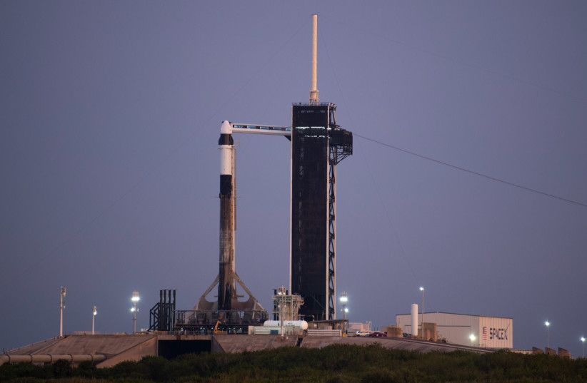 A SpaceX Falcon 9 rocket with the company's Crew Dragon spacecraft aboard is seen on the launch pad at Launch Complex 39A as preparations continue for the Axiom Mission 1 (Ax-1) at the Kennedy Space Center in Cape Canaveral, Florida.  (photo credit: Joel Kowsky/NASA via Getty Images)