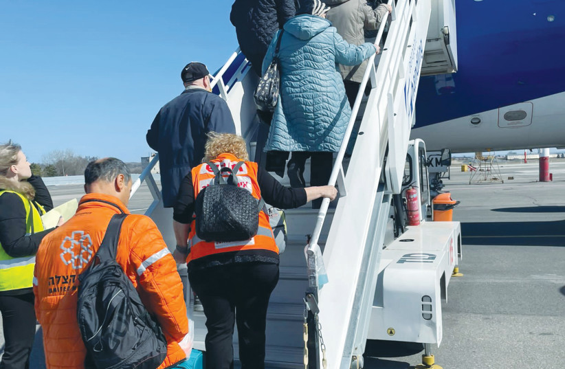  REFUGEES BOARD a plane to Israel on one of United Hatzalah’s rescue flights. (photo credit: UNITED HATZALAH‏)
