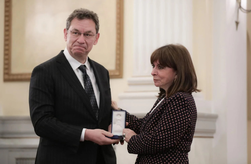  Greek President Katerina Sakellaropoulou (R) awards the medal of the Golden Cross of the Order of the Redeemer, to Pfizer President and CEO Albert Bourla (L), at a special ceremony at the Presidential Palace, Athens, Greece (photo credit: ALEXANDER BELTES/EPA)