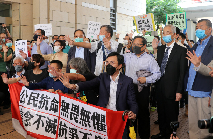  Pro-democracy activists chant slogans outside the West Kowloon Magistrates Court, in Hong Kong, China May 18, 2020. (credit: JESSIE PANG/REUTERS)