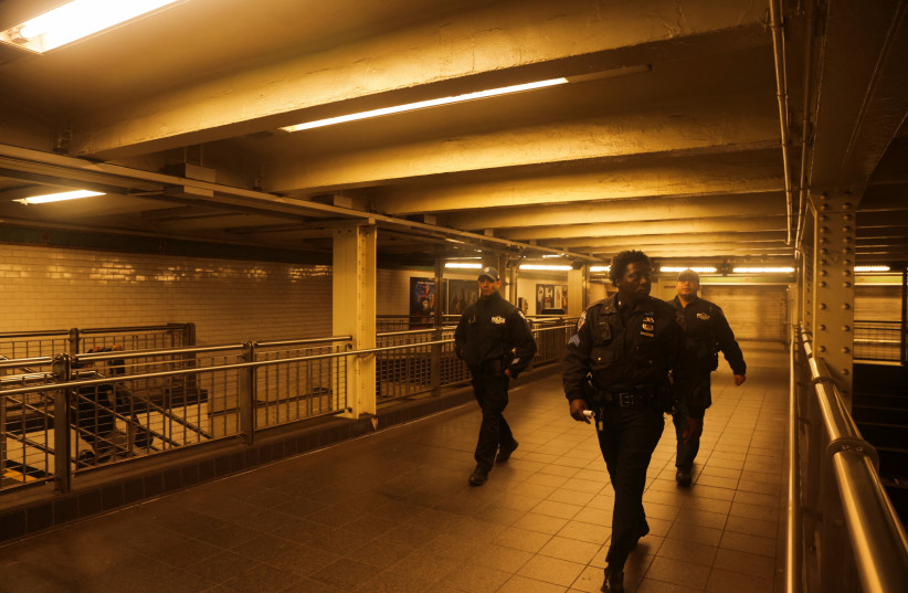  Metropolitan Transportation Authority workers check Manhattan subways after a shooting at a subway station in the Brooklyn borough of New York City, New York, US, April 12, 2022 (photo credit: REUTERS/JEENAH MOON)