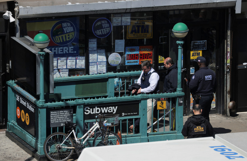  Law enforcement officers enter a subway station, the scene of a shooting, in the Brooklyn borough of New York City, New York, US, April 12, 2022. (credit: REUTERS/ANDREW KELLY)