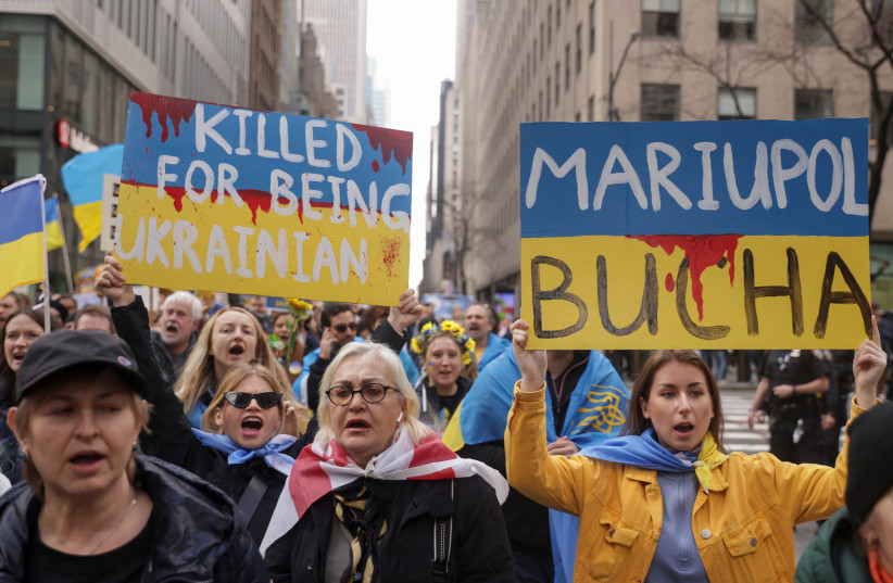 People attend a 'Stop Genocide of Ukraine People' rally and protest against Russia's invasion of Ukraine, in Times Square in New York City, US, April 9, 2022. (photo credit: REUTERS/JEENAH MOON)