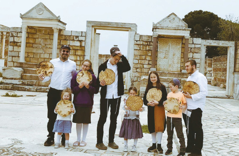  THE WRITER and his children, equipped with matzah for Passover, stand in front of a 2000-year-old synagogue in Sardis, Turkey. (photo credit: Chaya Chitrik)