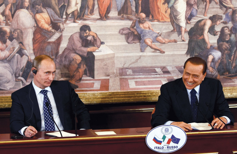  Former Italian prime minister Silvio Berlusconi smiles as Vladimir Putin looks on at a summit at Villa Gernetto in 2010. (credit: ALESSANDRO GAROFALO/REUTERS)