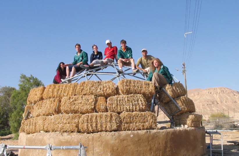  Reform Jewish Youth students during their year abroad program help Dutch master builder Itamar build the first of 10 dome eco campus houses at Kibbutz Lotan. (photo credit: KIBBUTZ LOTAN)