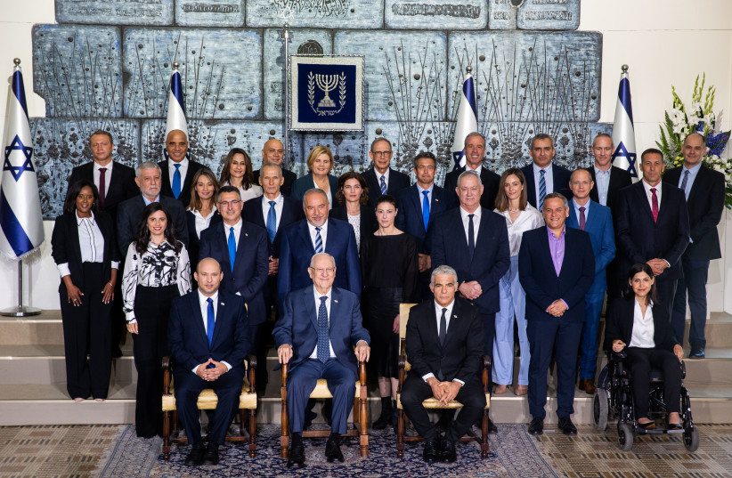 Israeli Prime Minister Naftali Bennett, Israeli Foreign Minister Yair Lapid, Israeli Presdint Reuven Rivlin and Israeli Ministers pose for a group photo of the newly sworn in Israeli government, at the President's Residence in Jerusalem on June 14, 2021. (credit: YONATAN SINDEL/FLASH90)