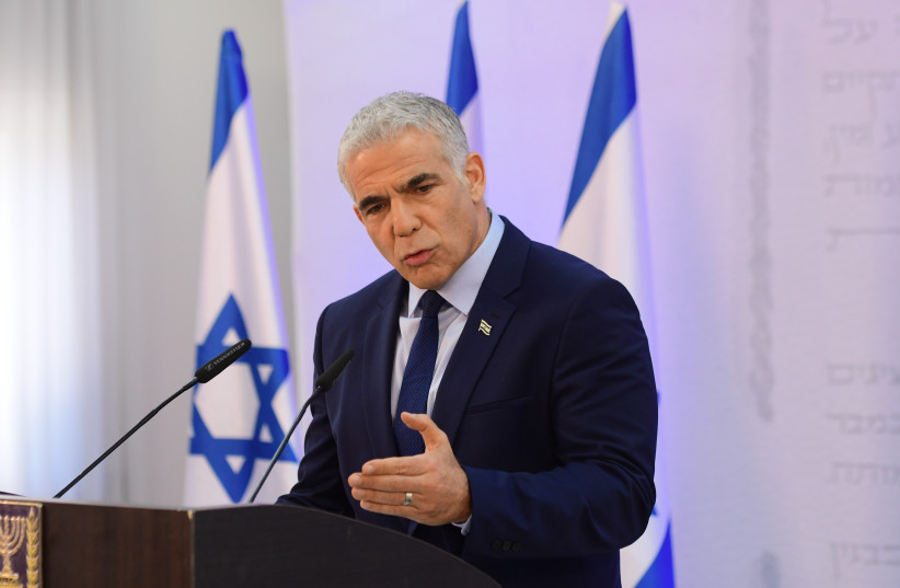 Head of the Yesh Atid party and Israeli foreign minister, Yair Lapid, holds a press conference in Tel Aviv on April 14, 2022. (credit: AVSHALOM SASSONI/FLASH90)