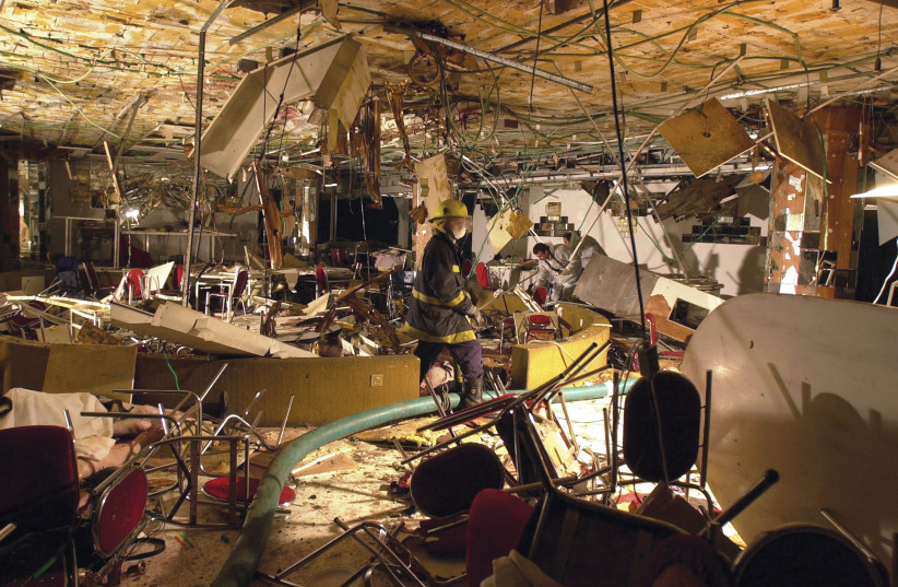 THE CARNAGE: Searching through the bombed-out interior. (credit: Scott Nelson/AFP via Getty Images)