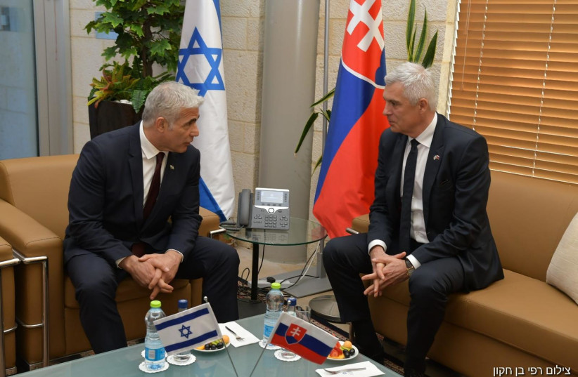  Foreign Minister Yair Lapid and Slovakian Foreign Minister Ivan Korcok.  (photo credit: RAFI BEN HAKOON/GPO)