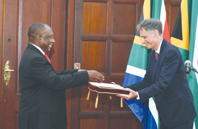  SOUTH AFRICAN President Cyril Ramaphosa smiles as he receives the credentials of new Israeli ambassador Eliav Belotsercovsky in January. (photo credit: Israel Embassy-South Africa/South African Dept. of International Relations and Cooperation/Twitter)