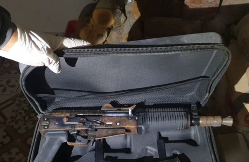  A Kalashnikov automatic rifle found in an Israel Police raid in the northern town of Daburiya on April 14, 2022.  (credit: ISRAEL POLICE SPOKESPERSON'S UNIT)