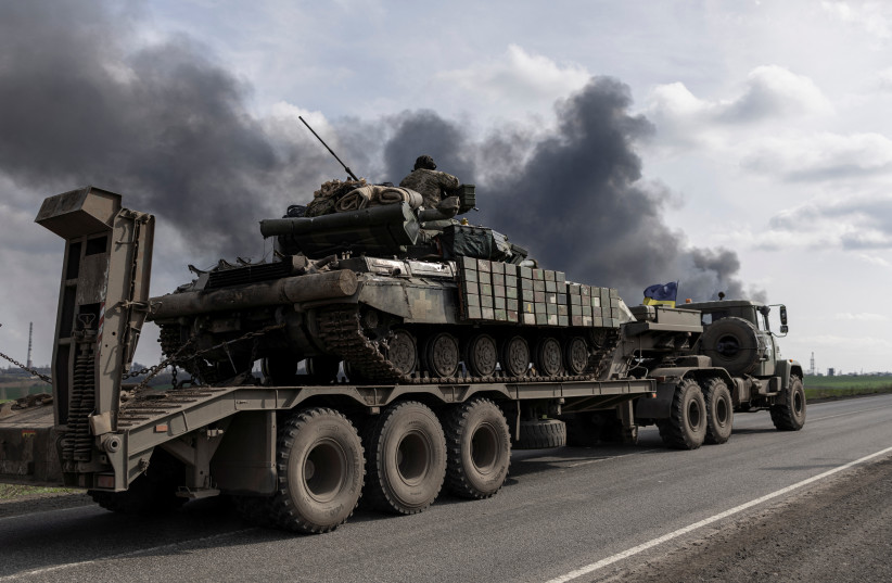  A Ukrainian soldier sits atop a tank passing the Lysychansk Oil Refinery after if was hit by a missile at Lysychansk, Luhansk region, Ukraine, April 16, 2022.  (credit: MARKO DJURICA/REUTERS)